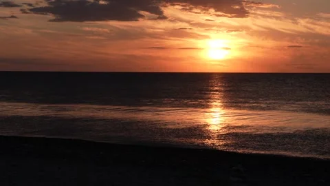 Dramatic sea sunrise. Burning sky and shining golden waves. Stock Footage 240249171