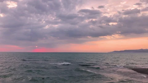 Dramatic sea sunrise. Burning sky and shining golden waves. Stock Footage 254730427
