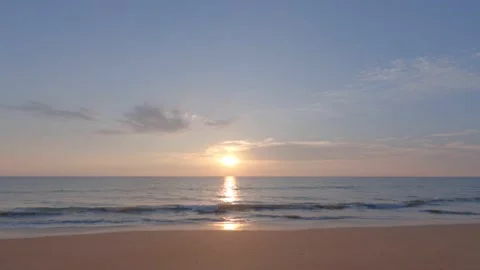 Dramatic sea sunrise. pinky sky and shining golden waves. silhouette people Stock Footage 169438152