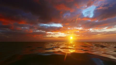 Dramatic sea sunrise with red sky and shining golden waves Stock Footage 166037469