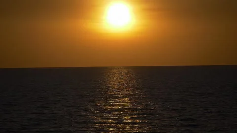 Dramatic sea sunset. Burning sky and shining golden waves. Sunset sea 4k. Red sk Stock Footage 294650405