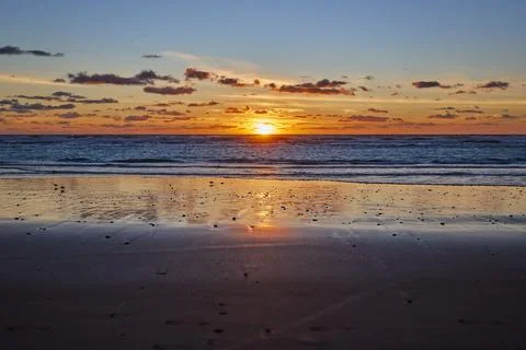 Dramatic sea sunset. The setting sun sinks into the sea Stock Photos