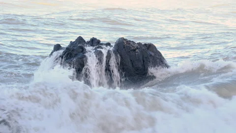 Dramatic sea waves crashing against dark coastal rocks at Tsikhisdziri Video stock 326742594