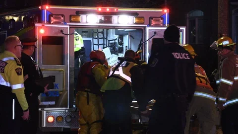 Dramatic search and rescue at night with police and fire searching pond Stock Footage 113319444