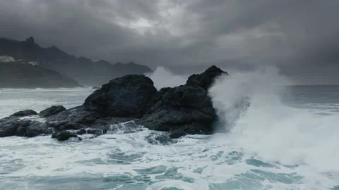 Dramatic Seascape in cold gray tones. Waves crash on the rocky shore. Stock Footage 146879679