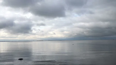 Dramatic seascape, dark cloudscape, smooth sea Stock Footage 254723800