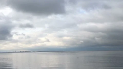 Dramatic seascape, panorama downwards, dark clouds reflected in sea water Stock Footage 254973980