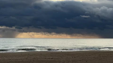 Dramatic seascape with storm clouds over calm ocean at sunset Stock Footage 295205655
