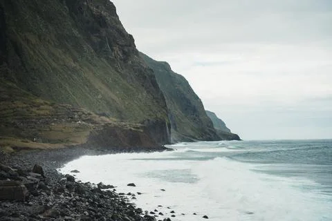Dramatic seascape view of a rugged coastline with crashing waves and toweri.. Stock Photos
