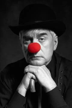 Dramatic selective color portrait of a clown against a dark background lean.. Foto stock