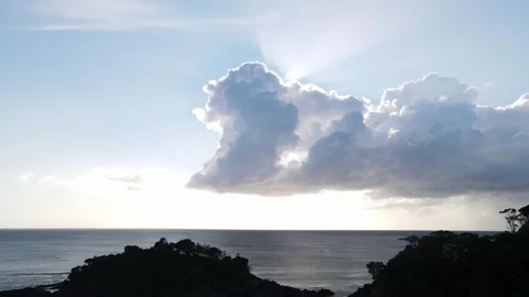 Dramatic shadow cast by a cloud across the scenic coastal headland, with the Stock Footage 317553750