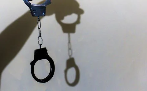 Dramatic Shadow of Police Handcuffs Representing Criminal Justice and Legal.. Stock Photos