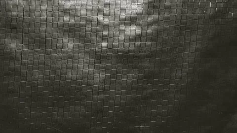 Dramatic shadows cast across intricate monochrome woven mesh grid texture in  Stock Photos