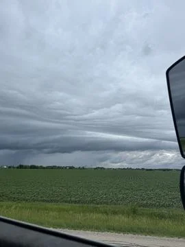 Dramatic Shelf Cloud Over a Green Agricultural Farmland and Road Stock Photos