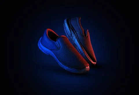 Dramatic shoe pair with blue and red light on dark background Stock Photos