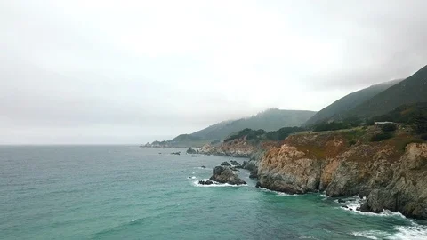 The dramatic shoreline of the Pacific ocean coast at sunset, Big Sur, California Stock Footage 92150216