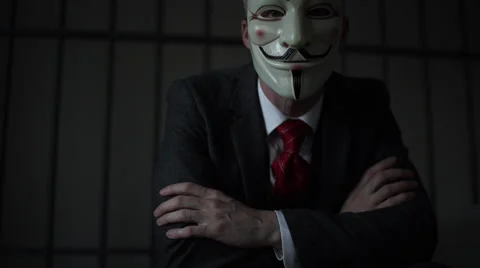 Dramatic shot of Anonymous hacker in prison Stock Footage 60574466