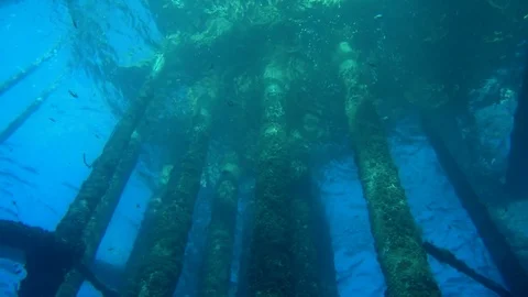 Dramatic shot looking up at oil gas platform from underwater view perspective Stock Footage 71887484