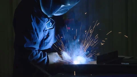 Dramatic shot of Man Welding in USA Factory Working with Steel American Job Video stock 136785194