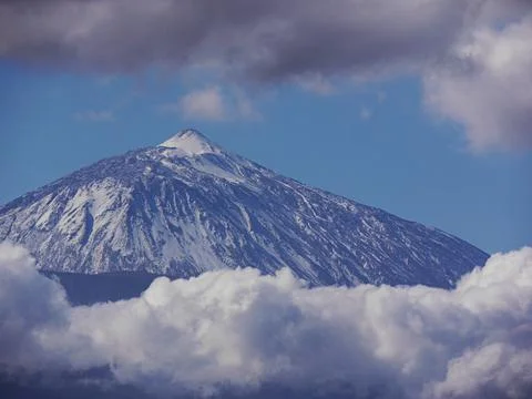 Dramatic shot of snowcapped Mount Teide, Tenerife and clouds. Stock Photos