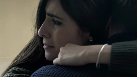 Dramatic show slow motion of woman scared about the future in pain hugging wo Stock Footage 128434160