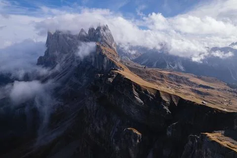 Dramatic side view of the Seceda mountain in clouds Stock Photos