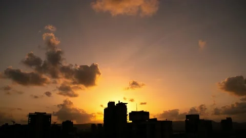 Dramatic silhouette city skyline timelapse at sunset with clouds moving over Stock Footage 133182325