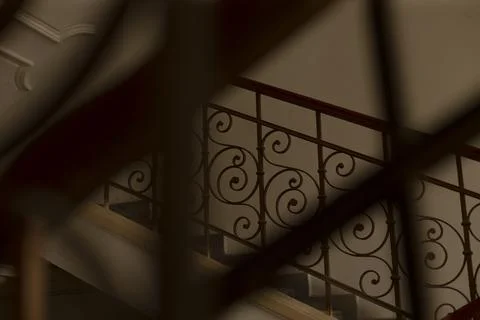 Dramatic silhouette of ironwork against textured plaster background Stock Photos
