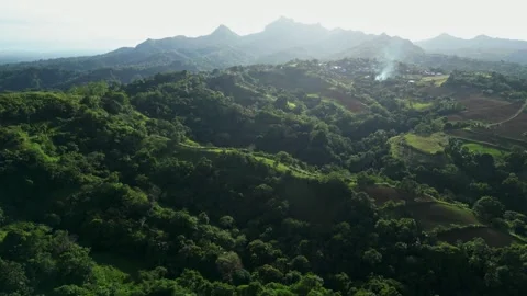 A dramatic silhouette shot of Mt. Batulao against glowing sky with layered Vídeo Stock 331320319