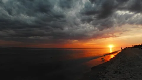 Dramatic skies over the seashore at sunset Stock Footage 274083458