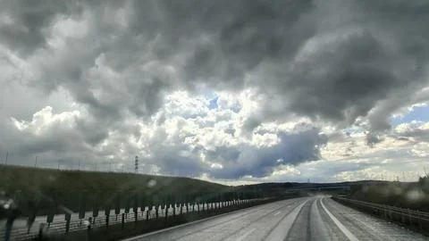 Dramatic skies over a winding road on a cloudy day Fotos Stock
