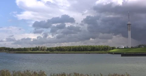 Dramatic sky above causeway, sluice and lock complex Houtribsluizen Stock Footage 69983641