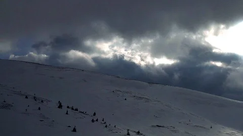 Dramatic sky above the snow-covered mountain slope Stock Footage 99598948