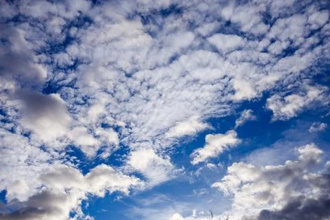 Dramatic Sky with Altocumulus Clouds and Contrail Stock Photos