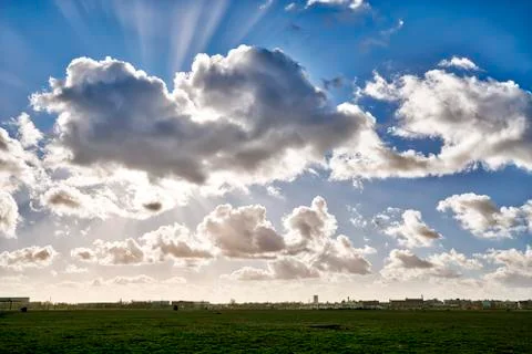 Dramatic sky and meadow with the skyline of Berlin Stock Photos
