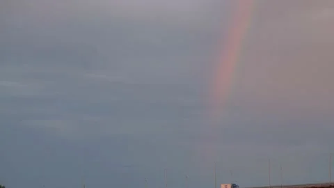 Dramatic sky and rainbow. Rainbow over the river. Rainbow over the bridge. Big Stock Footage 217823332