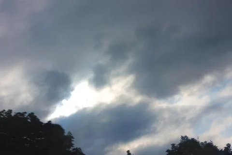 Dramatic sky and rays falling through the clouds Stock Photos