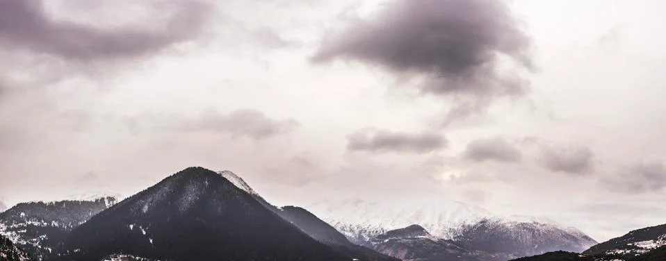 Dramatic sky and snowfall on a mountain line in North Greece.Panorama Stock Photos