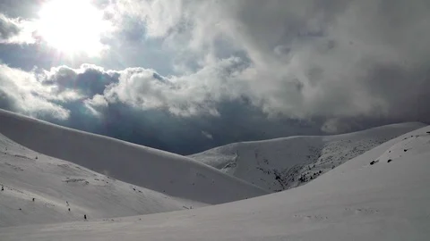 Dramatic sky and sun in the snow-capped mountains Video stock 102396132