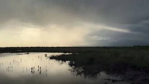 Dramatic Sky and Sunrays Reflected on Tranquil Wetlands at Dusk, China Stock Footage 336838873