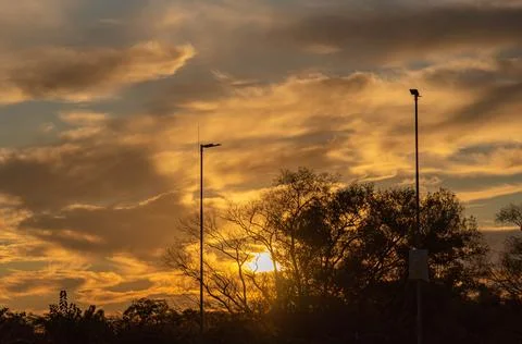 Dramatic sky and sunset silhouette in a mall parking lot in Brazil Stock Photos
