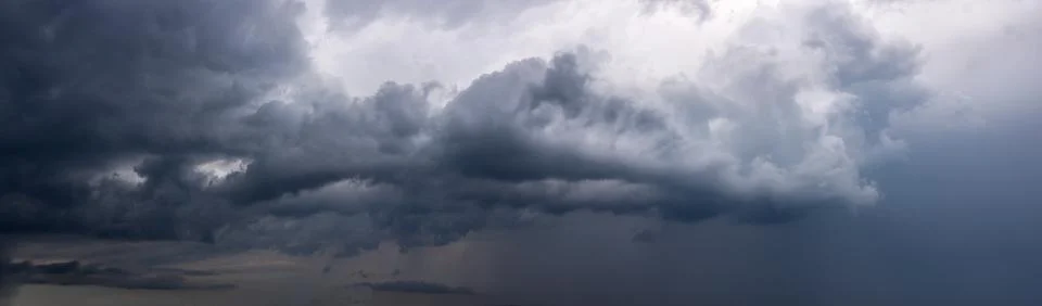 Dramatic sky background with dark rainy clouds before the storm. Stock Photos