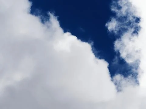 Dramatic sky. Beautiful clouds on a background of dark blue sky. Stock Photos