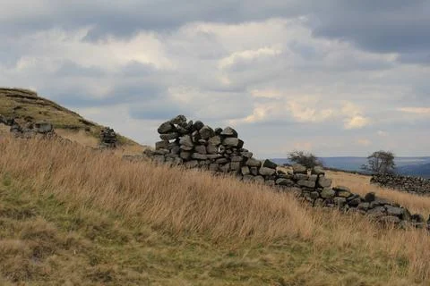 Dramatic sky behind crumbling stone wall Stock Photos