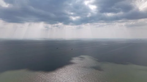 Dramatic sky breaks through storm clouds above ocean Stock Footage 337728451
