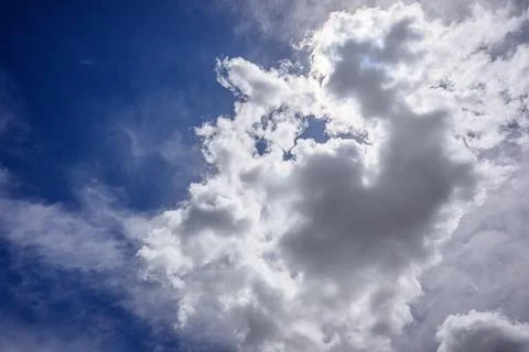 Dramatic sky with bright white clouds against vivid blue background Stock Photos