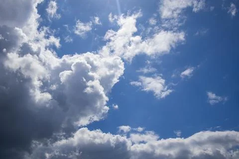 Dramatic sky with bright white cumulus clouds and deep blue background, Stock Photos