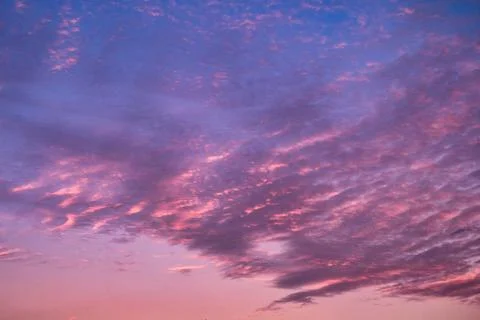 Dramatic sky with cirrocumulus clouds in the sunset Stock Photos