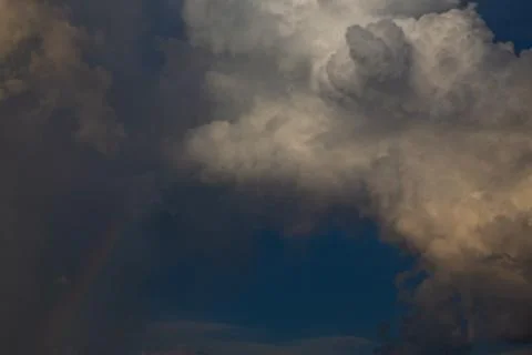 Dramatic sky with clouds and a rainbow Stock Photos