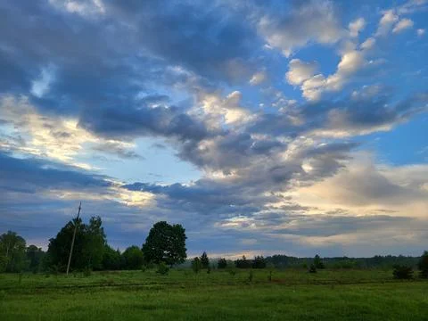 Dramatic sky with clouds and sunlight over horizon Stock Photos